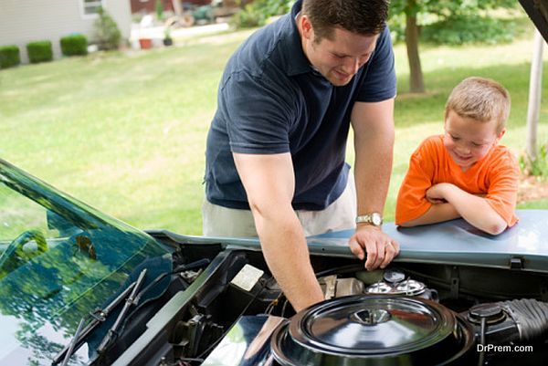 Father and son repairing car