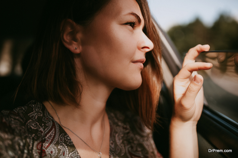 beautiful woman looking outside the car