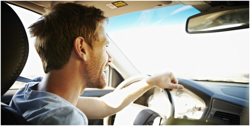 man enjoying the long drive in his car