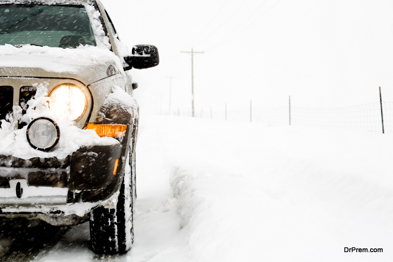 SUV 4x4 on a snowy day, illuminated headlight, close up with limited dof and copyspace